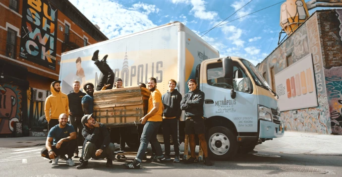 3 women standing beside white van during daytime